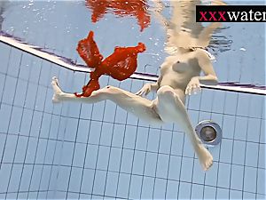 beautiful red-hot female swimming in the pool