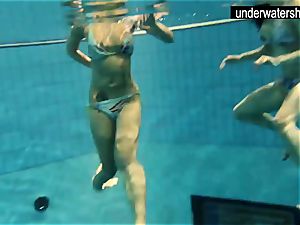 2 beautiful amateurs displaying their figures off under water